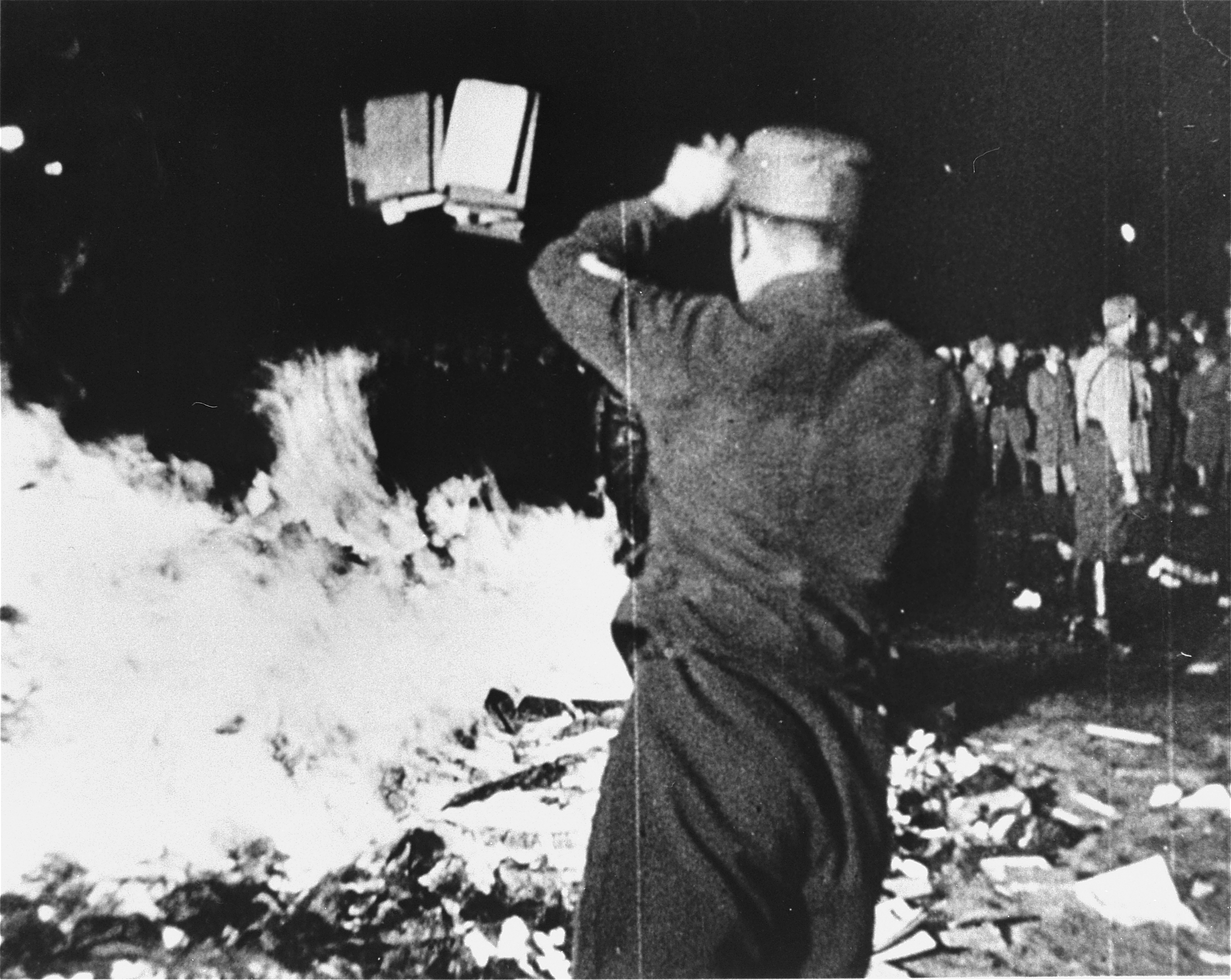 Image of a man looking at a pile of burning books from Hirschfeld’s Institute