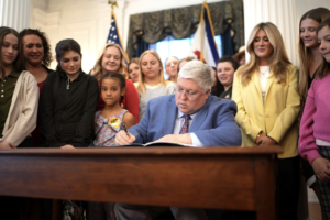 Governor Patrick Morrisey joined by Riley Gaines and other supporters to sign into law HB 456, the Riley Gaines Act.